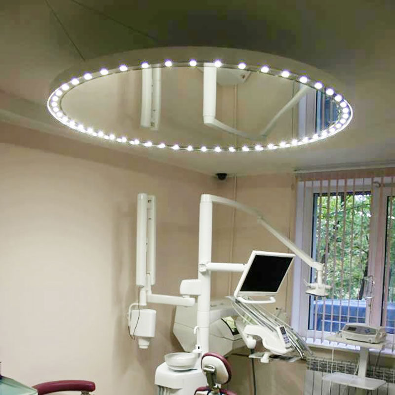 Dental surgical light with mirror