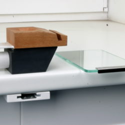 There is a part under the tabletop that is fixed on the bottom of the dental table; this part is the holder of the bench filing pin.